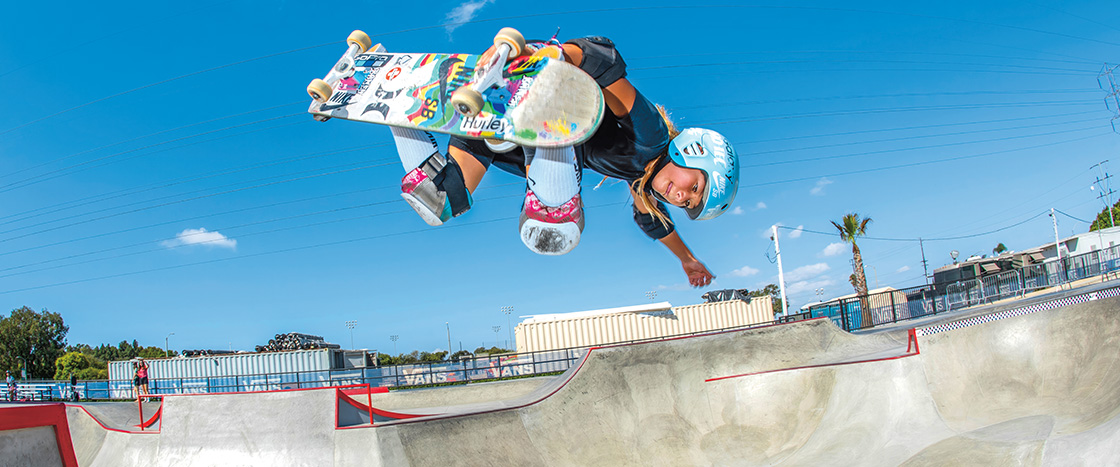 Photo of a female skateboarder performing a trick