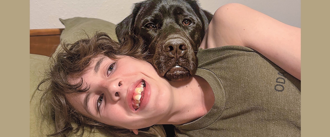 Image of teen pictured with guide dog