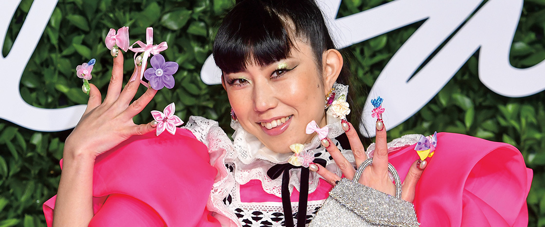 Image of person wearing fancy outfit with very fancy nails